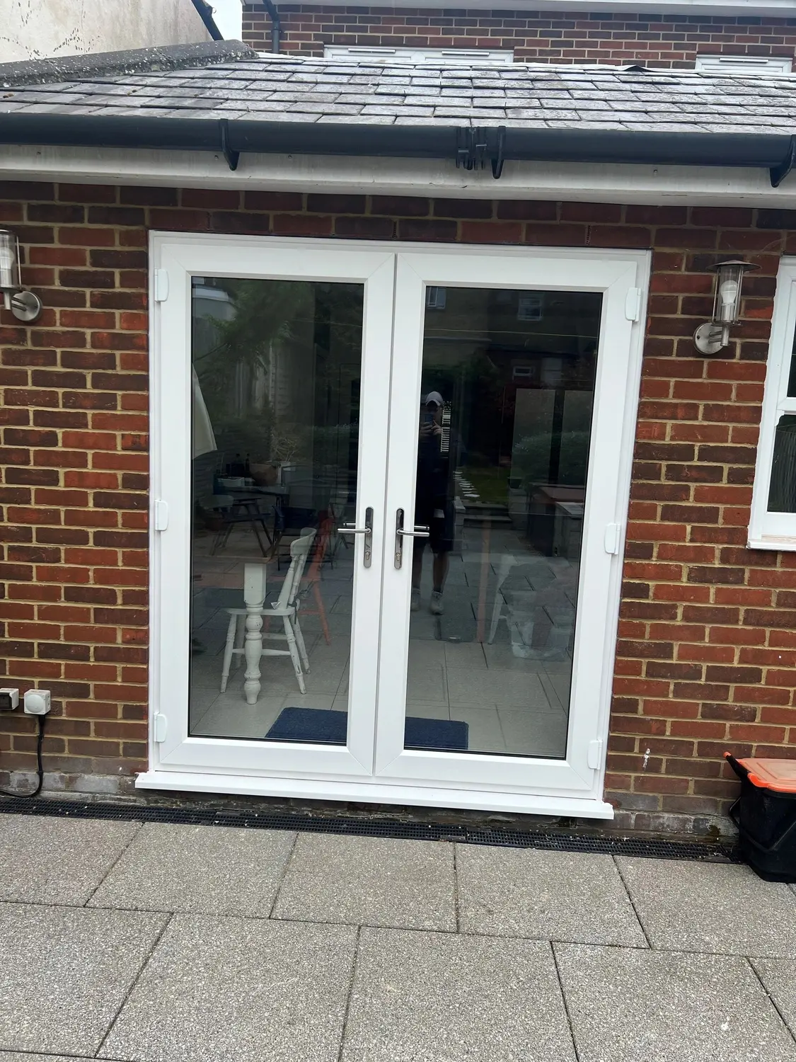 White UPVC French doors opening onto a paved patio